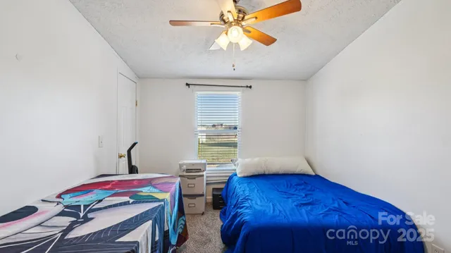 a bedroom with furniture and a window