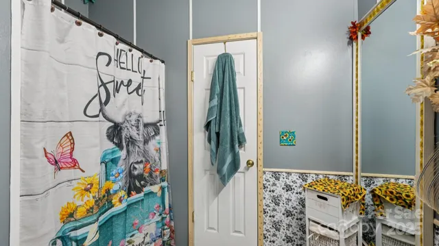 a bath room with a couch and a flat screen tv