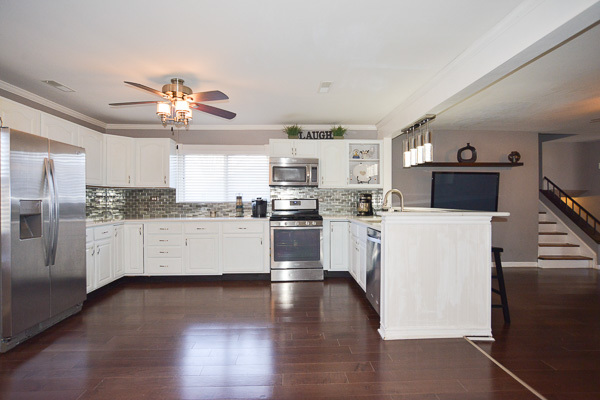 720 Durham Lane Hoffman Estates, IL 60169 - Photo 11 of 34 a kitchen with a refrigerator a stove top oven a sink and cabinets