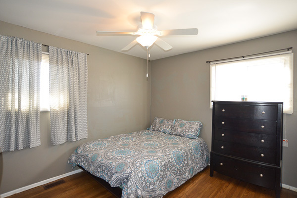 720 Durham Lane Hoffman Estates, IL 60169 - Photo 14 of 34 a bedroom with a bed and a chandelier