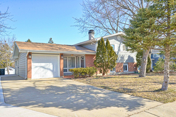 720 Durham Lane Hoffman Estates, IL 60169 - Photo 3 of 34 a view of a house with snow on the road