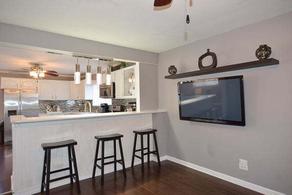 720 Durham Lane Hoffman Estates, IL 60169 - Photo 6 of 34 a kitchen with stainless steel appliances granite countertop a microwave a stove and white cabinets with wooden floor