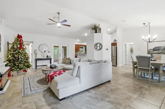 a living room with furniture and a chandelier