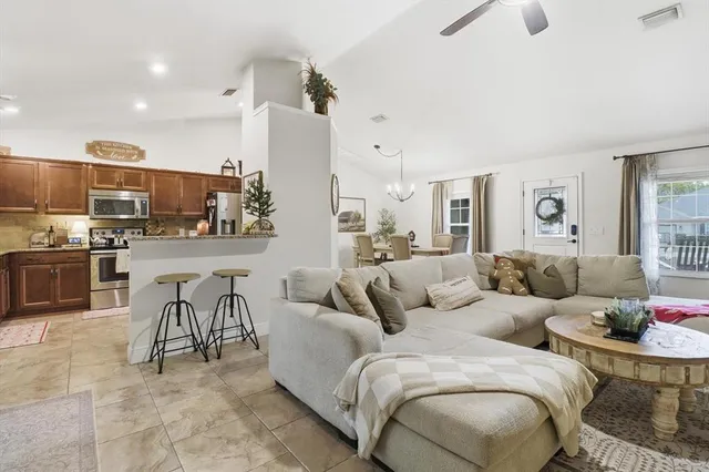 a living room with furniture and kitchen view