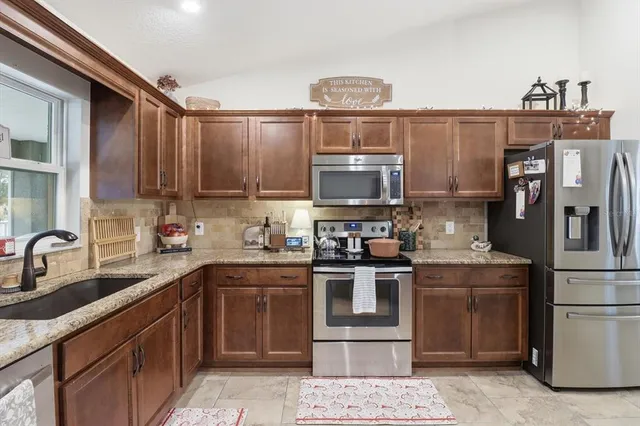 a kitchen with a sink a stove and refrigerator