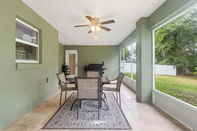 a dining room with wooden floor and a rug