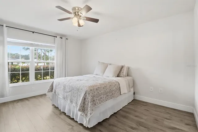 a bedroom with a large bed and a large window