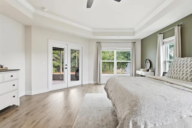 a bedroom with a bed and large window