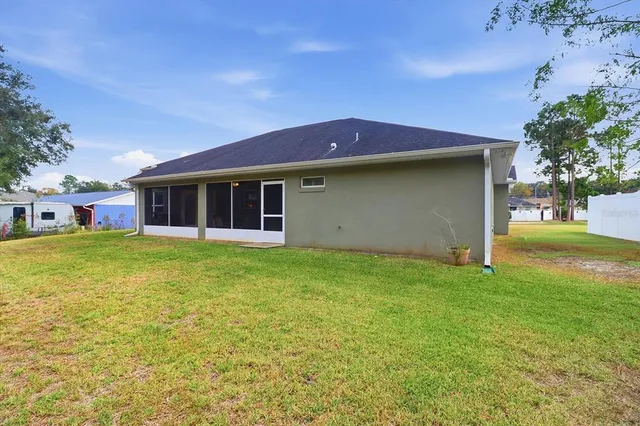 a view of a house with a garden and yard