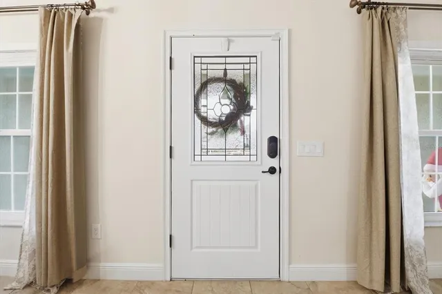 a view of a hallway with wooden floor and door