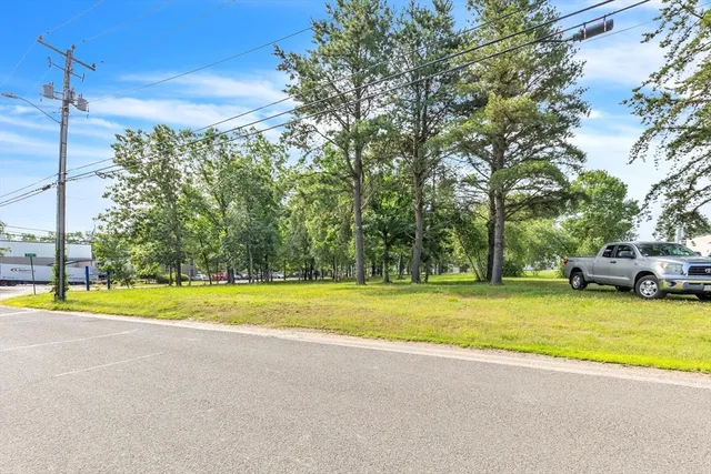 a view of a swimming pool and trees in the background