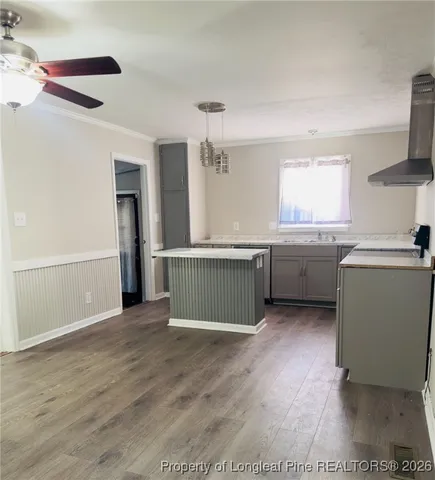 a view of a kitchen with a sink dishwasher and a fireplace