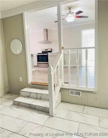 a view of a livingroom with wooden floor and a large windows
