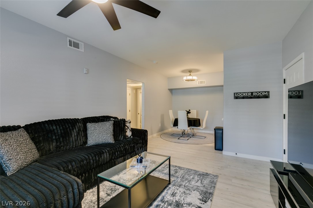 7255 West Sunset Road, Unit 1103 Las Vegas, NV 89113 - Photo 15 of 35 An open concept living area transitions smoothly into a dining space, ideal for modern living.