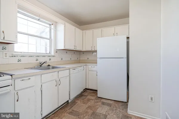 a white refrigerator freezer sitting inside of a kitchen