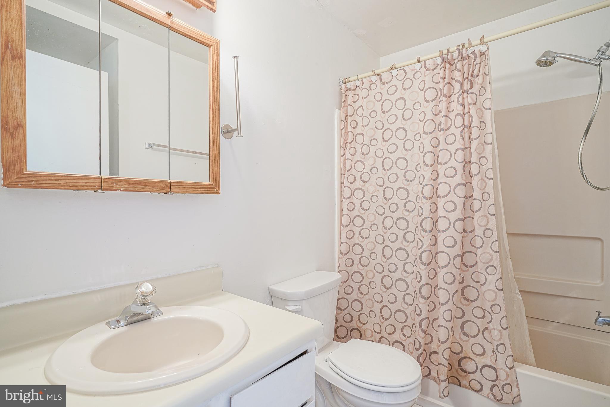 605 Woodchip Road Lumberton, NJ 08048 - Photo 9 of 18 a bathroom with a sink a toilet and shower curtain
