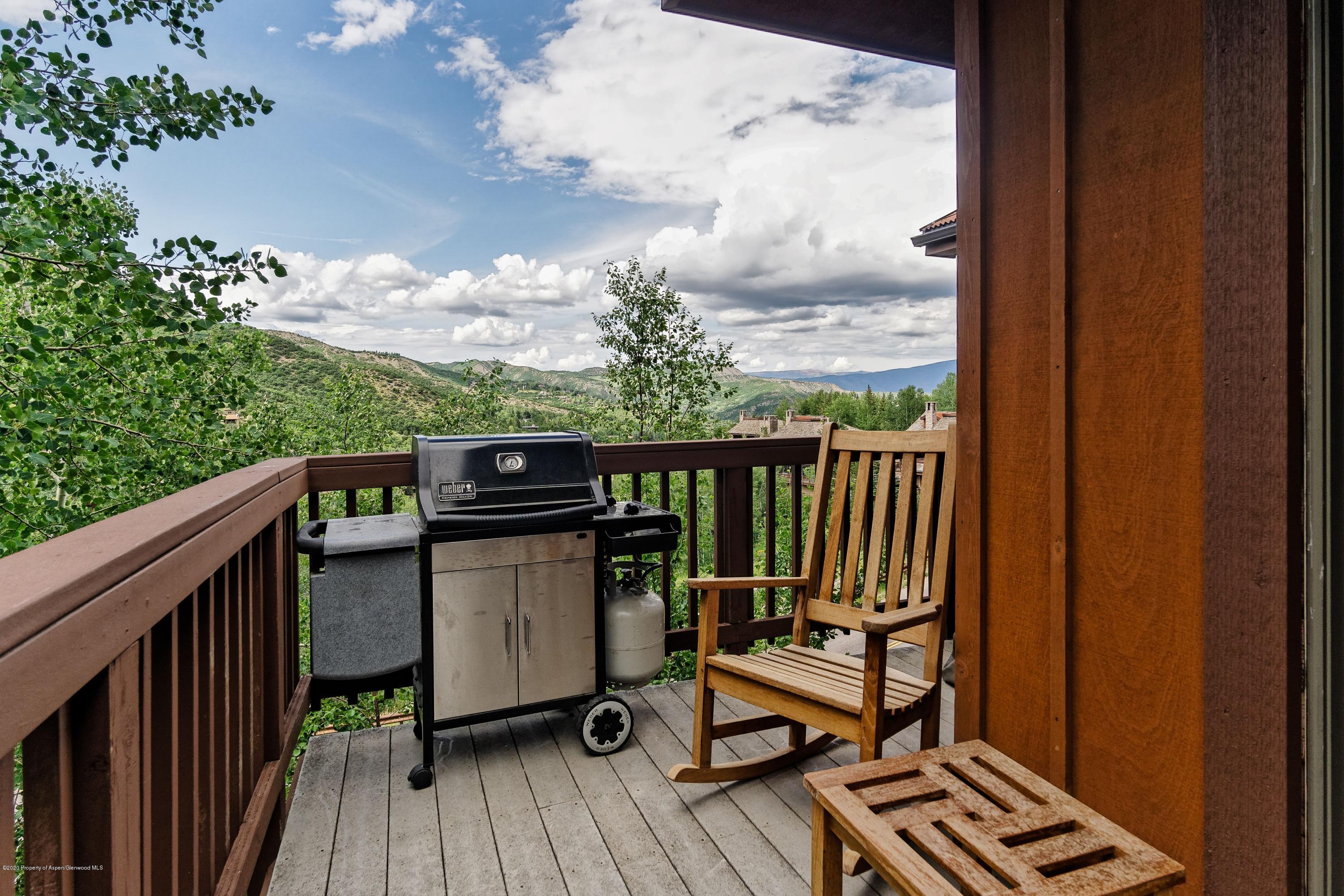 800 Ridge Road, Unit 14 Snowmass Village, CO 81615 - Photo 12 of 20 a view of a balcony with wooden floor and outdoor seating