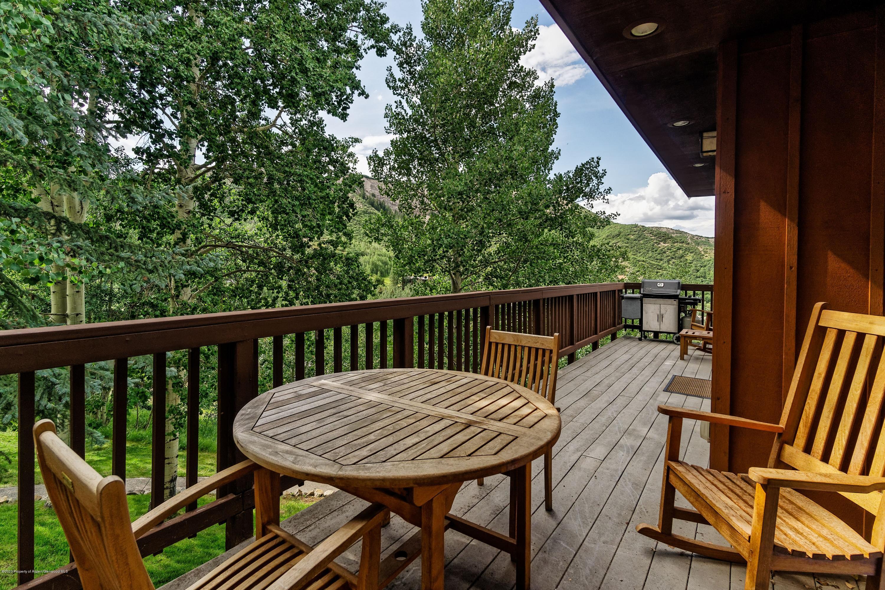 800 Ridge Road, Unit 14 Snowmass Village, CO 81615 - Photo 14 of 20 a view of a deck with a table and chairs