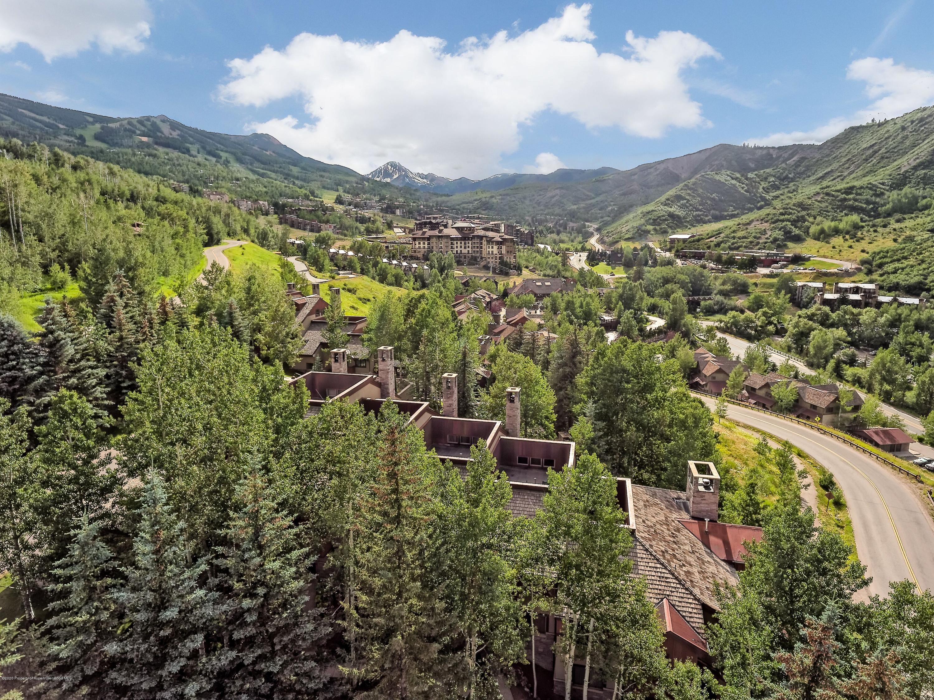 800 Ridge Road, Unit 14 Snowmass Village, CO 81615 - Photo 18 of 20 a view of a city with lush green forest