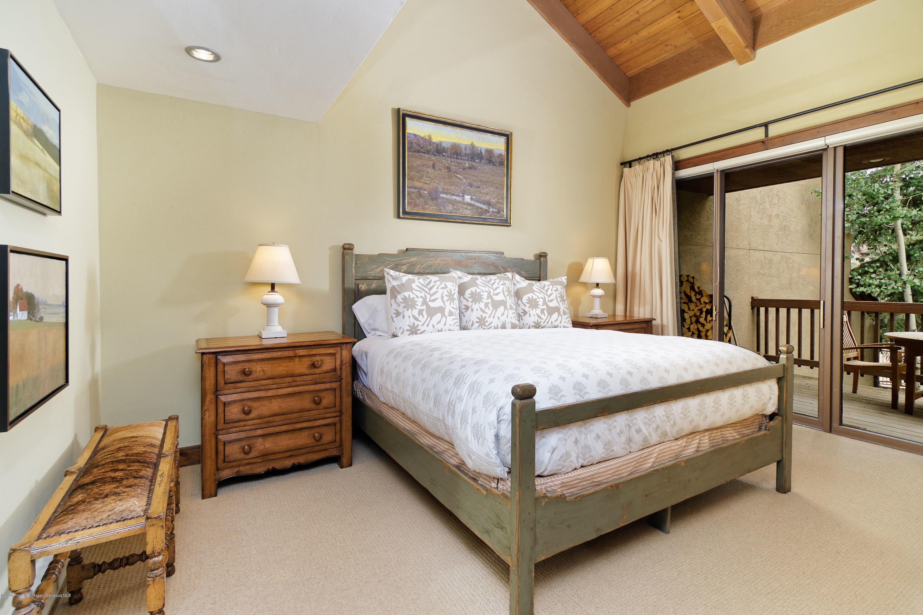 800 Ridge Road, Unit 14 Snowmass Village, CO 81615 - Photo 8 of 20 a bed sitting in a bedroom next to a window