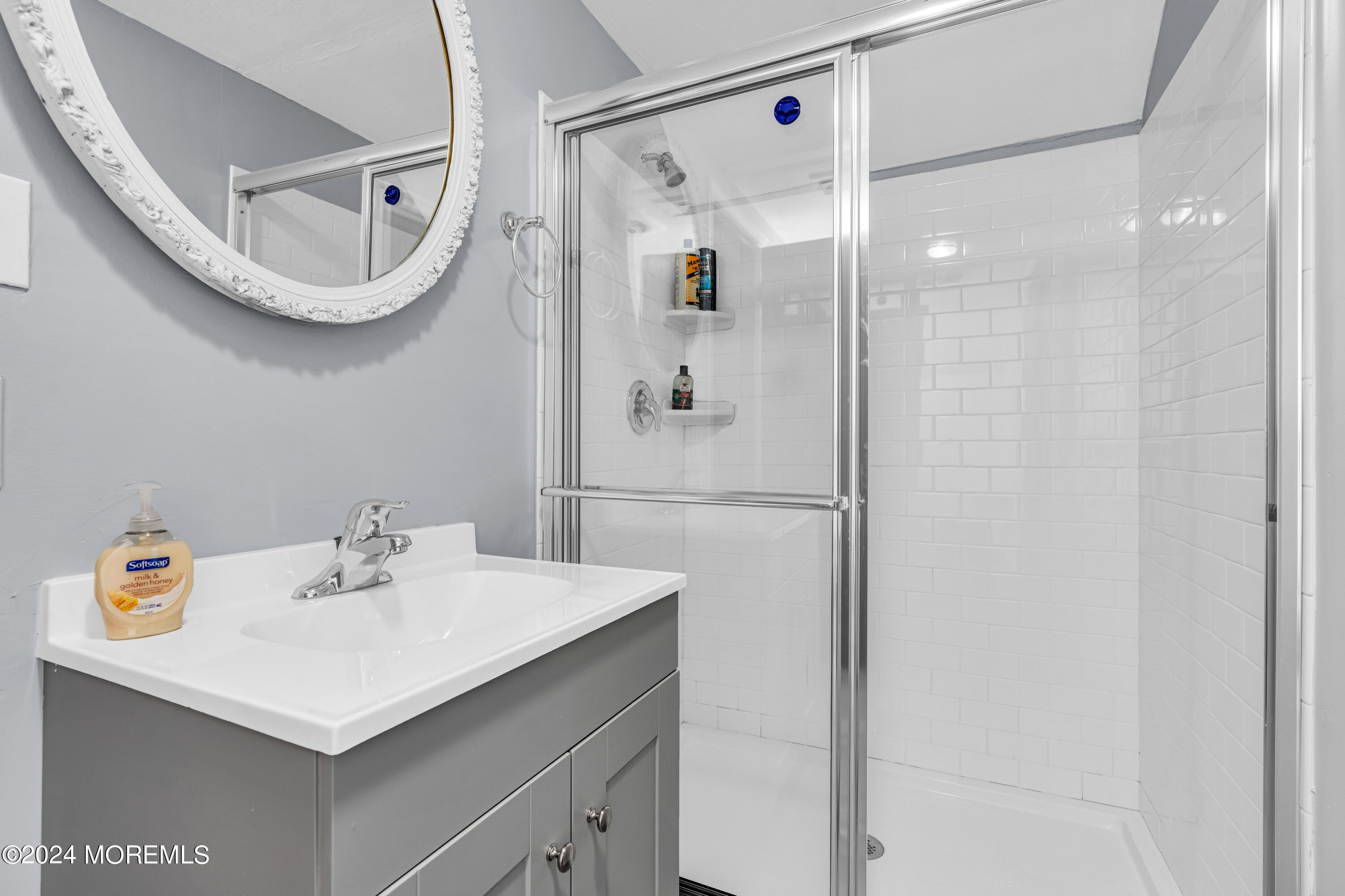 139 Broadway Road Freehold, NJ 07728 - Photo 23 of 37 a bathroom with a sink a mirror a vanity and shower