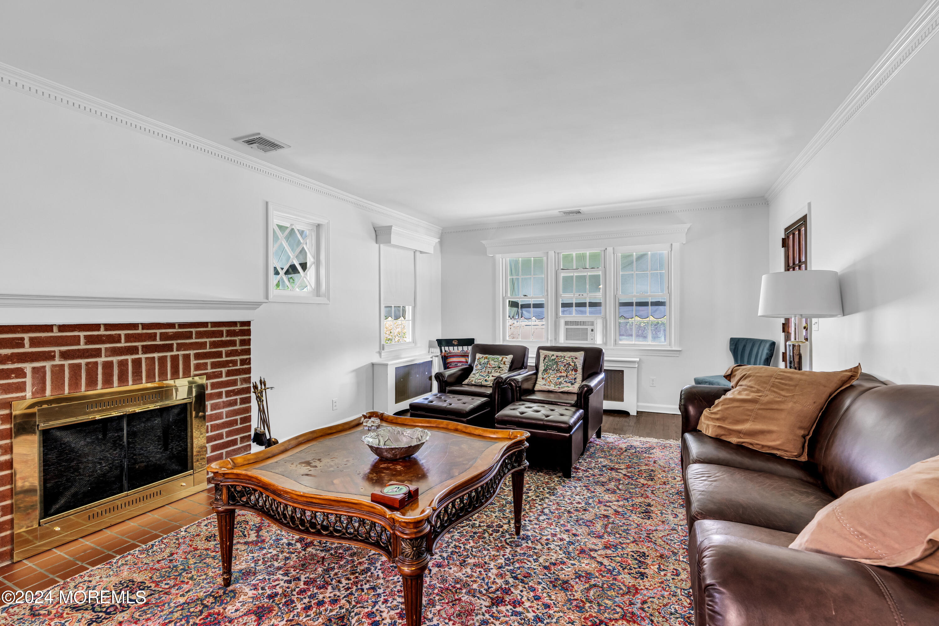 139 Broadway Road Freehold, NJ 07728 - Photo 6 of 37 a living room with furniture a rug and a fireplace