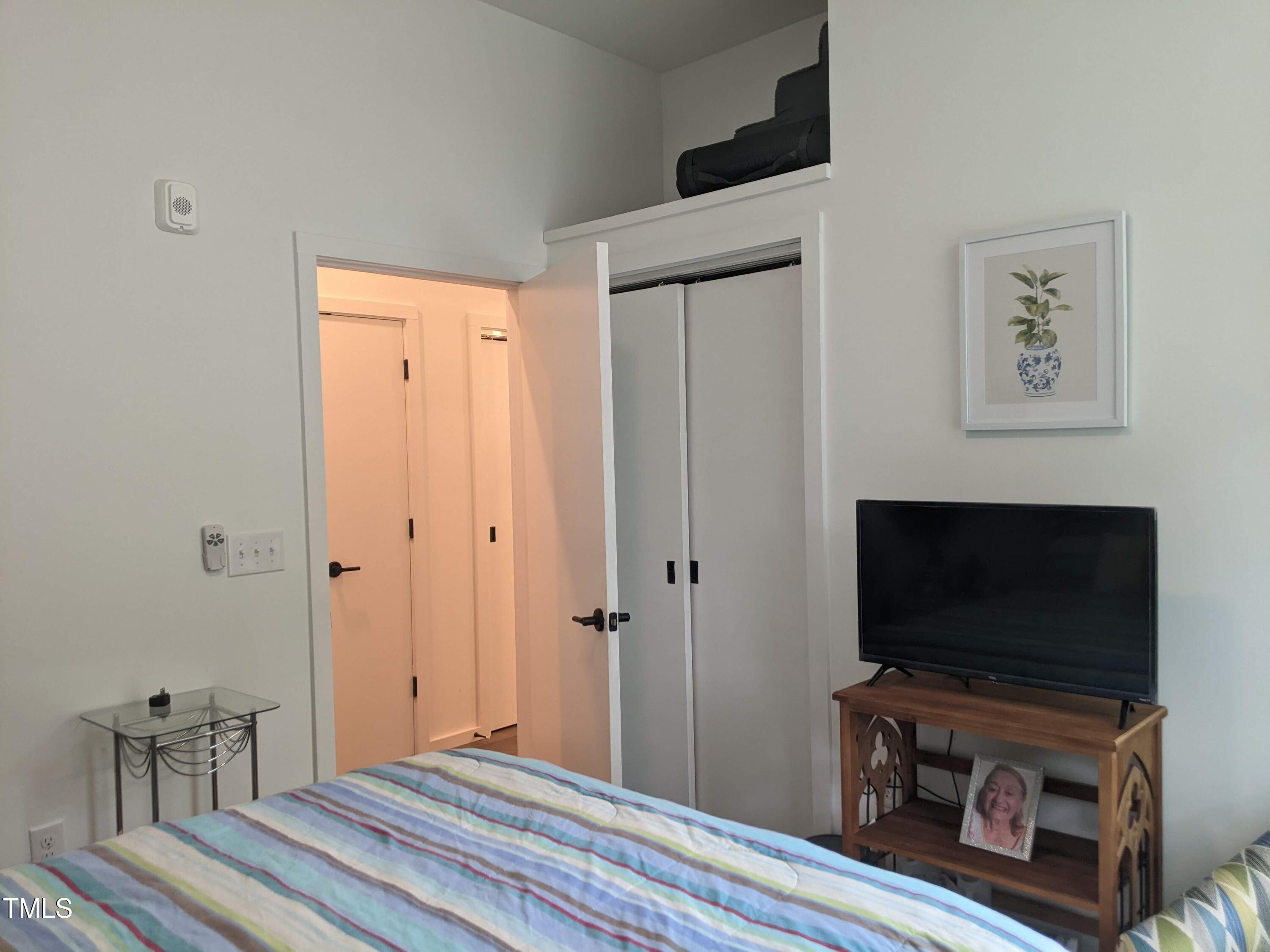 600 South Duke Street, Unit 11 Durham, NC 27701 - Photo 12 of 16 a bedroom with furniture and a flat screen tv