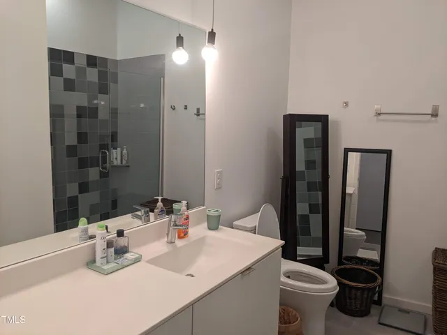 a bathroom with a sink toilet and shower