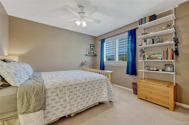 a bedroom with a bed wooden floor and window