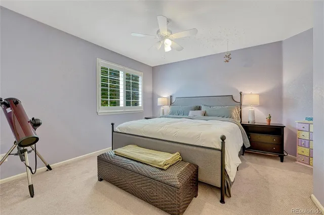 a bedroom with a bed a desk and chair