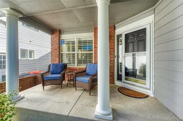 a balcony with furniture and a potted plant