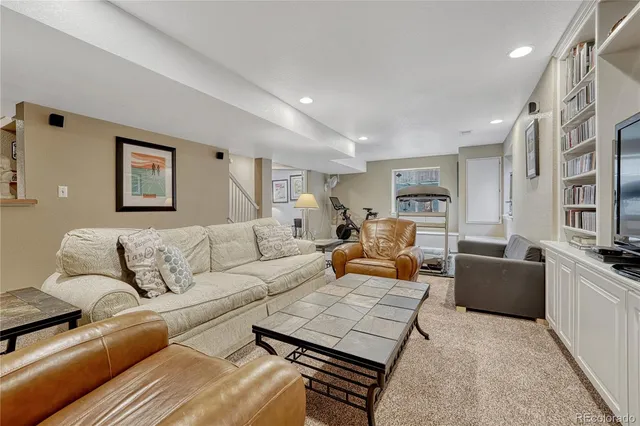 a living room with furniture a couch and a flat screen tv