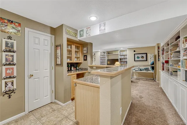 a kitchen with stainless steel appliances a stove refrigerator and cabinets