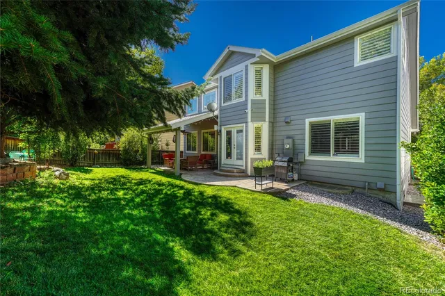 a view of a house with backyard porch and sitting area