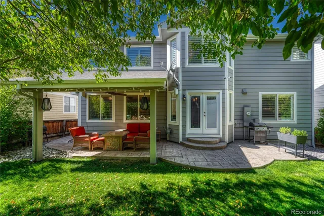a view of a house with a backyard and a patio