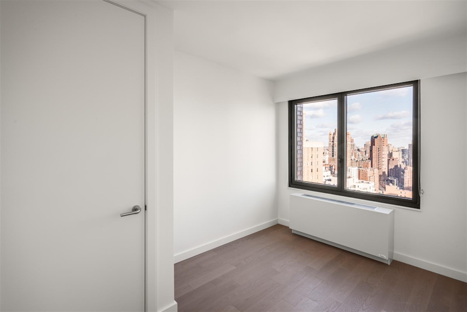 220 East 72nd Street, Unit 21E Manhattan, NY 10021 - Photo 5 of 11 a view of an empty room with a window