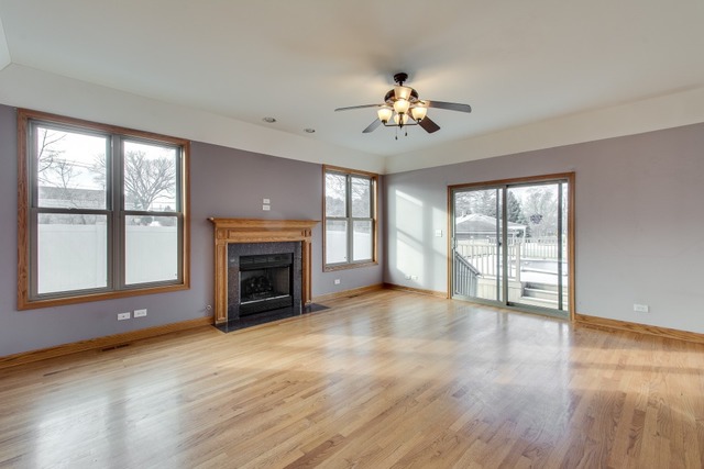 501 West Edgewood Road Lombard, IL 60148 - Photo 8 of 12 a view of an empty room with a fireplace and a window