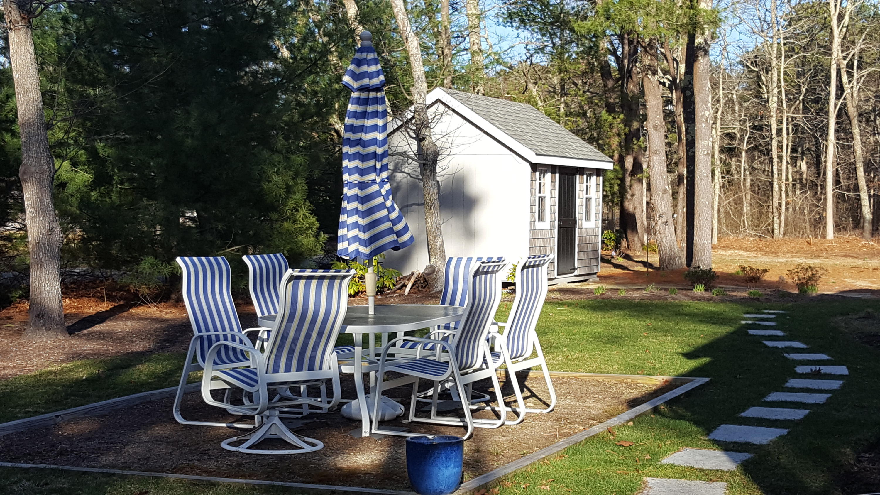 8 Nehoiden Road Mashpee, MA 02649 - Photo 16 of 47 a view of a chairs and table in backyard of the house