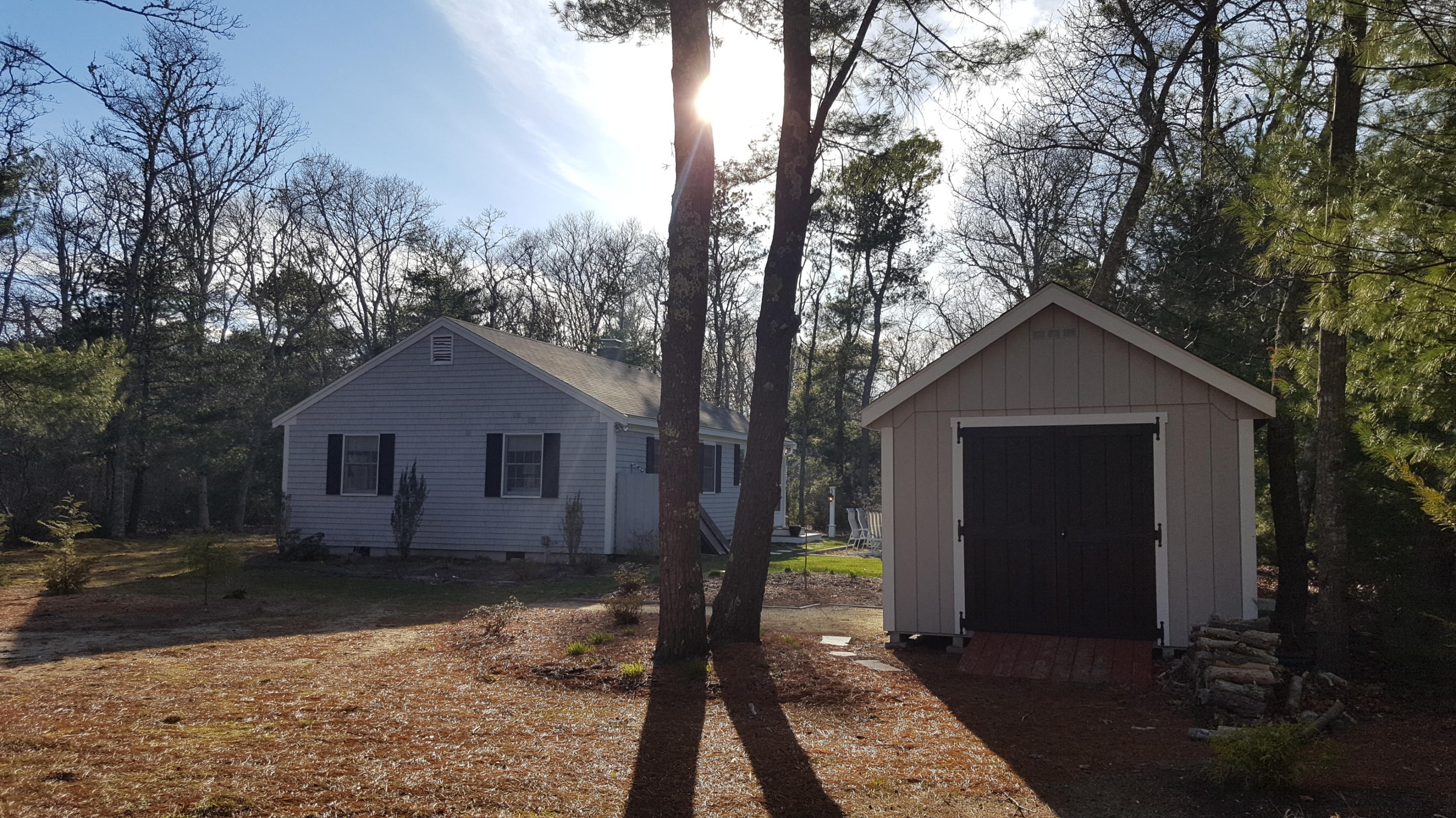 8 Nehoiden Road Mashpee, MA 02649 - Photo 19 of 47 a front view of house with yard and trees in the background