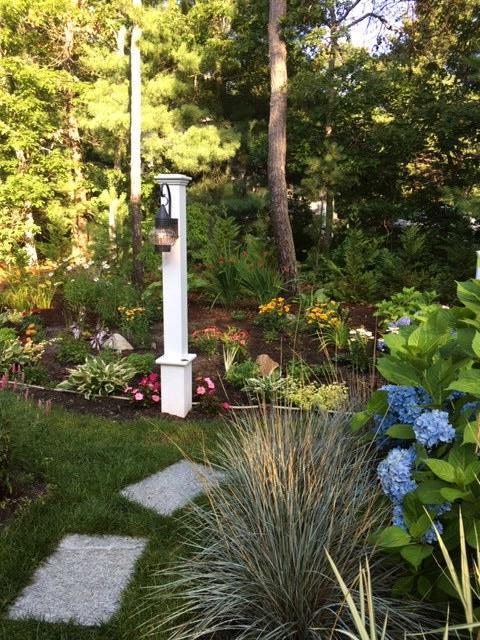 8 Nehoiden Road Mashpee, MA 02649 - Photo 26 of 47 a front view of a house with garden