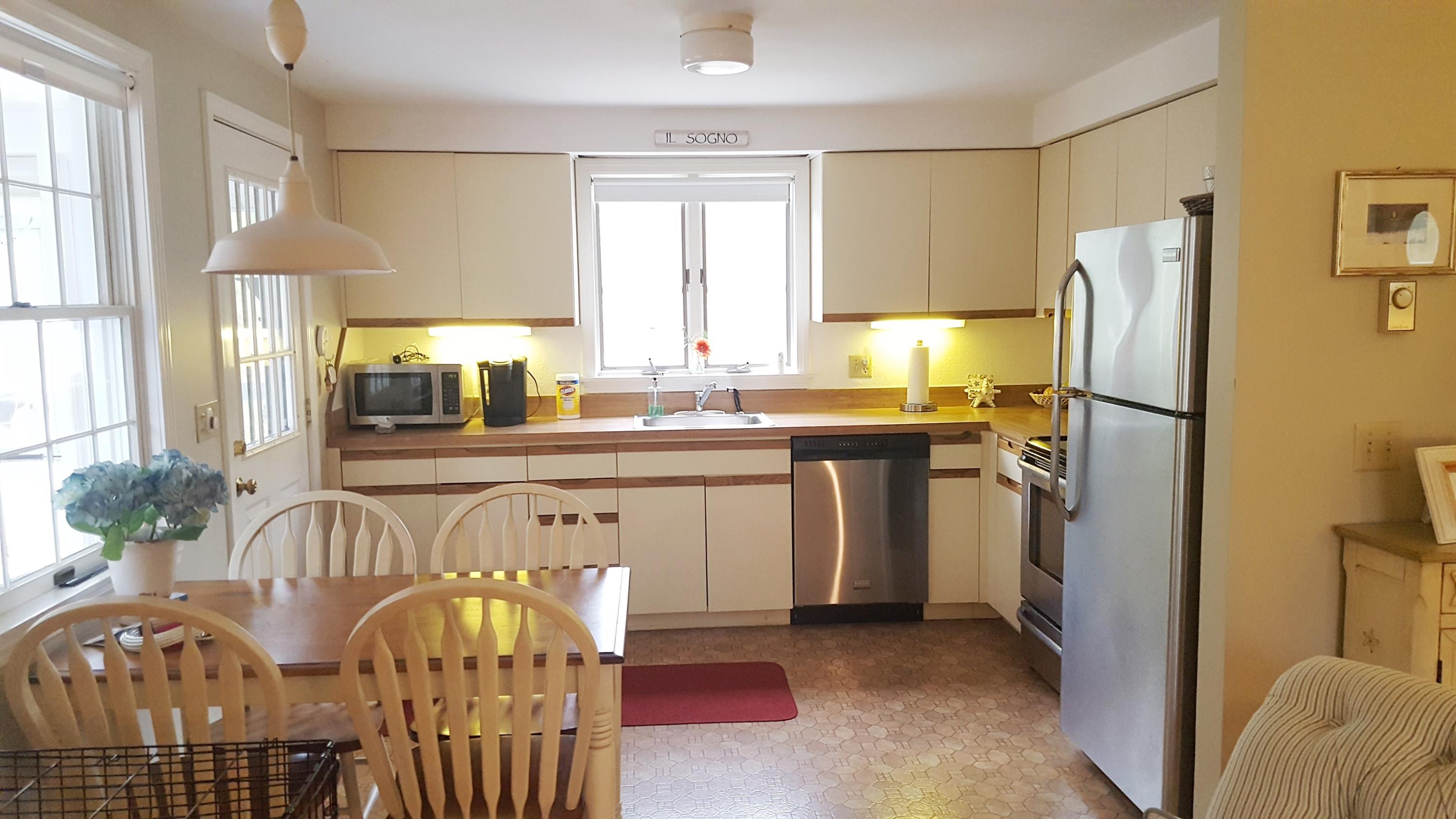 8 Nehoiden Road Mashpee, MA 02649 - Photo 8 of 47 a kitchen with stainless steel appliances granite countertop a refrigerator sink and cabinets