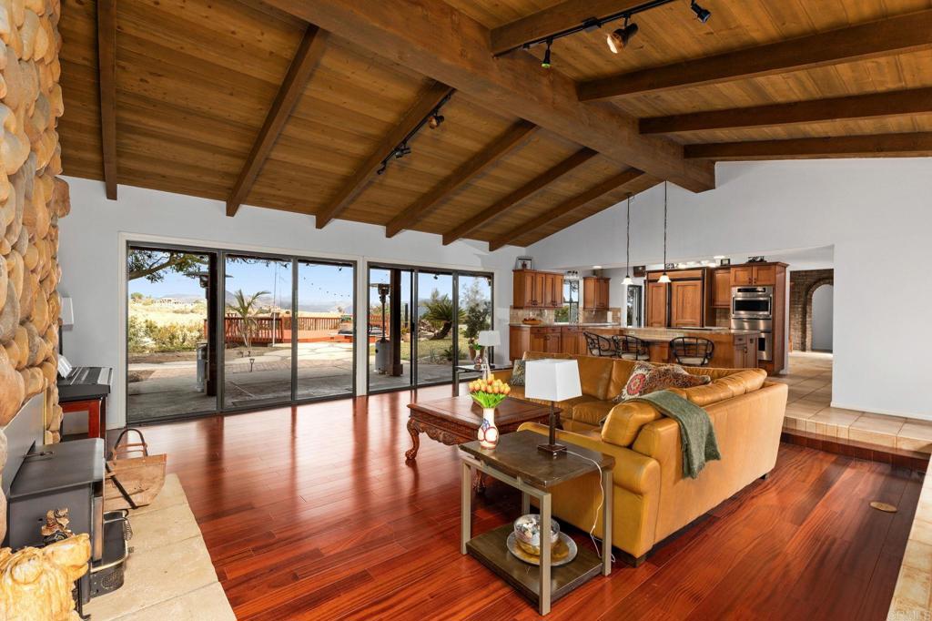 15735 Highland Valley Road Escondido, CA 92025 - Photo 16 of 38 a living room with patio lots of furniture and wooden floor