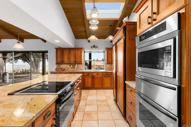 a kitchen with stainless steel appliances granite countertop a sink and stove