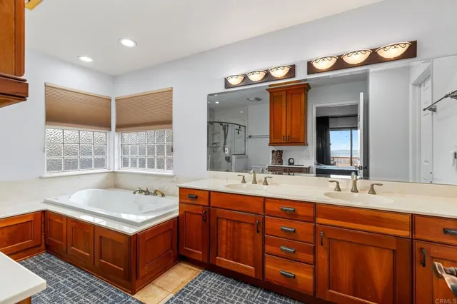 a bathroom with a tub sink and mirror