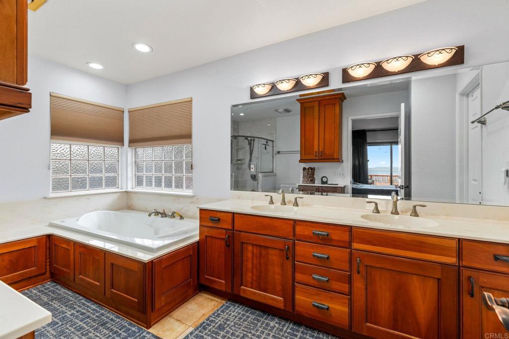 15735 Highland Valley Road Escondido, CA 92025 - Photo 21 of 38 a bathroom with a tub sink and mirror