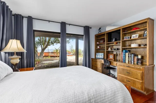 a bedroom with a large bed and a bookshelf