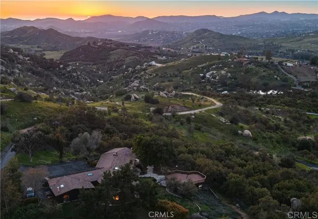 an aerial view of residential house and sandy dunes