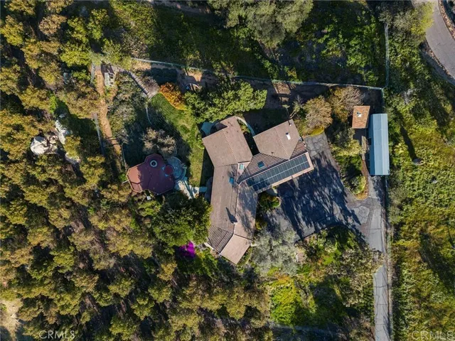 an aerial view of a house with a yard and garden