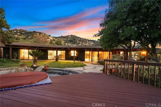 a view of a house with backyard patio and a garden
