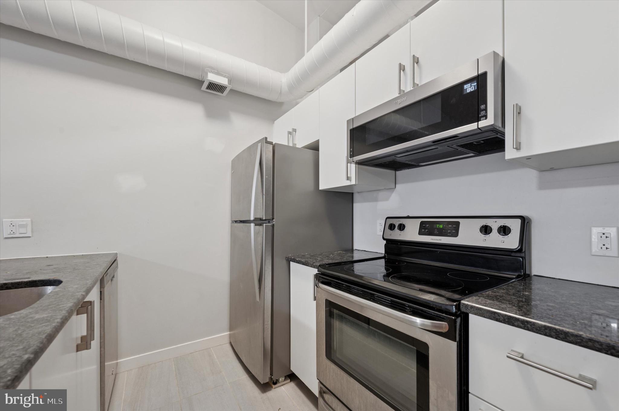 222 Church Street, Unit 2J Philadelphia, PA 19106 - Photo 12 of 17 a kitchen with stainless steel appliances a stove microwave and sink